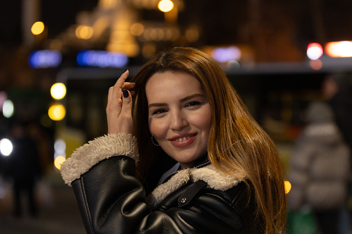 Portrait of beautiful young woman in front of city lights.
Istanbul - Turkey.