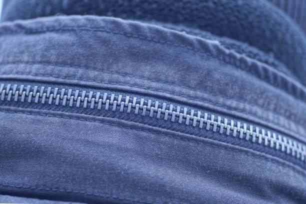 one long closed metal zip on a black gray cloth pocket on a garment