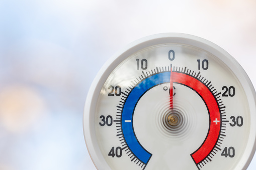 Close-up shot of outdoor thermometer with Celsius scale displays the freezing point temperature