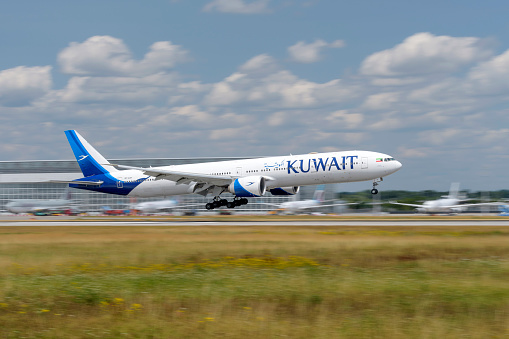 Munich, Germany - July 06. 2023 : Kuwait Airways Boeing 777-369ER with the aircraft registration 9K-AOH during landing on the southern runway 08R of the Munich Airport MUC EDDM