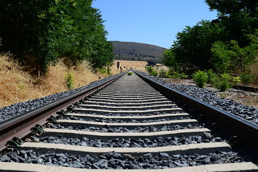 A closeup of the railway tracks running through the countryside