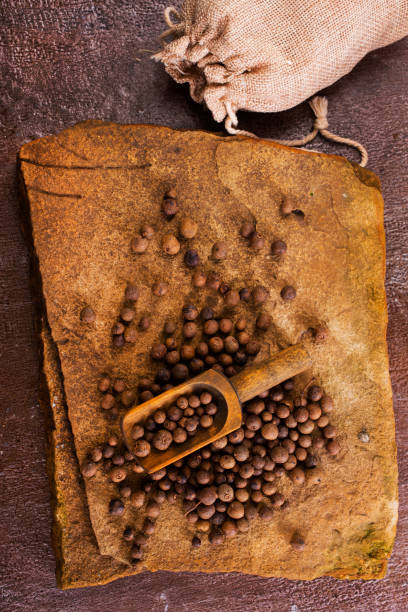 istock Black pepper in bow on wooden table 1962441219