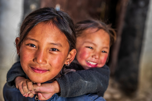 Two Tibetan young girls from Lo Manthang, Upper Mustang. Mustang region is the former Kingdom of Lo and now part of Nepal,  in the north-central part of that country, bordering the People's Republic of China on the Tibetan plateau between the Nepalese provinces of Dolpo and Manang.