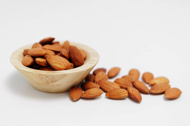 istock bowl of almond nuts on white table background 1962448093