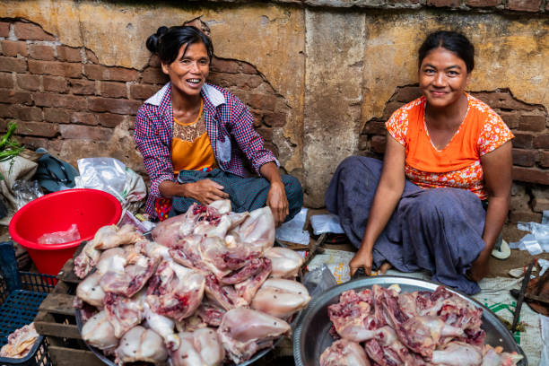 Burmese women selling raw meat on a local market in Bagan, Myanmar
