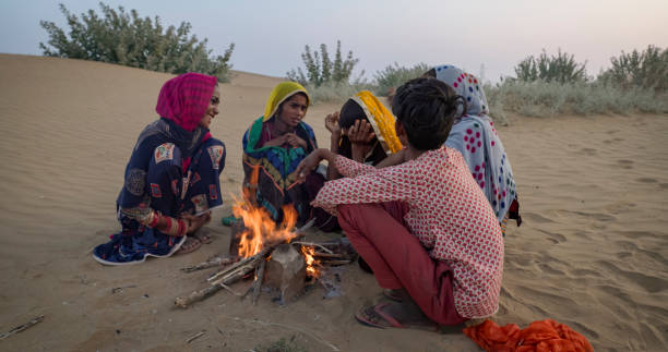 istock Indian kids setting up bonfire on sand dune 1962449136
