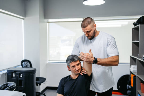 istock Physical Therapist Adjusting His Male Client's Arm In His Office 1962455429