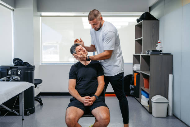 istock Physical Therapist Adjusting His Male Client's Neck In His Office 1962456990