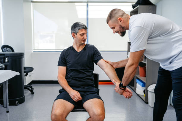 istock Physical Therapist Adjusting His Male Client's Arm In His Office 1962463949