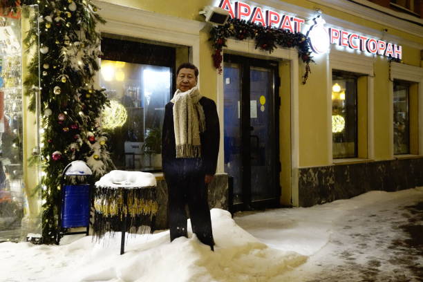Xi Jinping cutout figure in the snow Moscow, Russia - December 2023: A cardboard cutout figure of China Chairman Xi Jinping for taking pictures with in the snow on the Arbat in Moscow xi jinping stock pictures, royalty-free photos & images