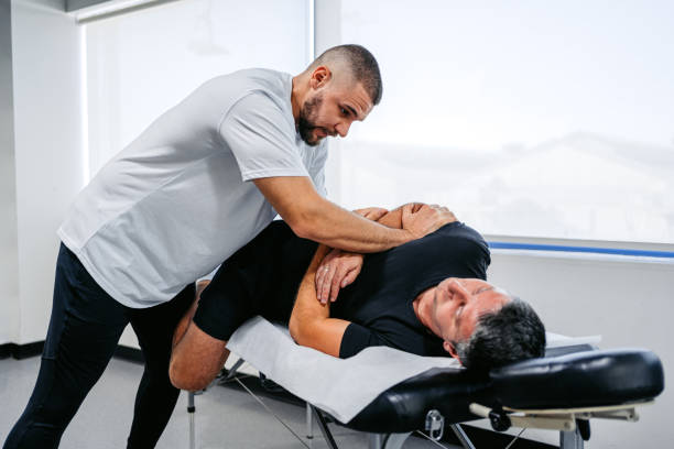 istock Chiropractor Adjusting His Male Client's Lower Back In His Office 1962468780
