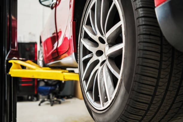 istock Modern Car on a Auto Service Lift Being Repaired 1962469877