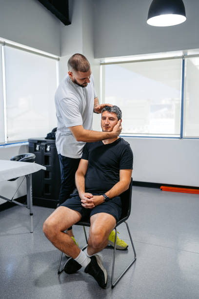 istock Physical Therapist Adjusting His Male Client's Neck In His Office 1962470901
