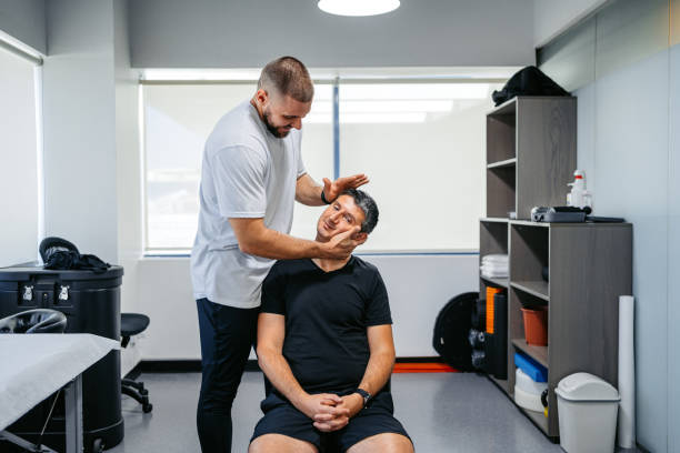 istock Physical Therapist Adjusting His Male Client's Neck In His Office 1962471427