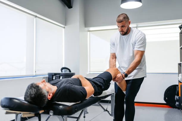 istock Physical Therapist Massaging His Male Client's Leg In His Office 1962471445