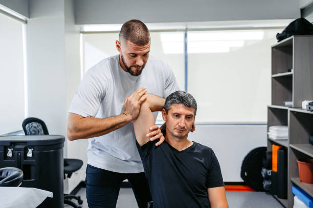 istock Physical Therapist Adjusting His Male Client's Arm In His Office 1962473036