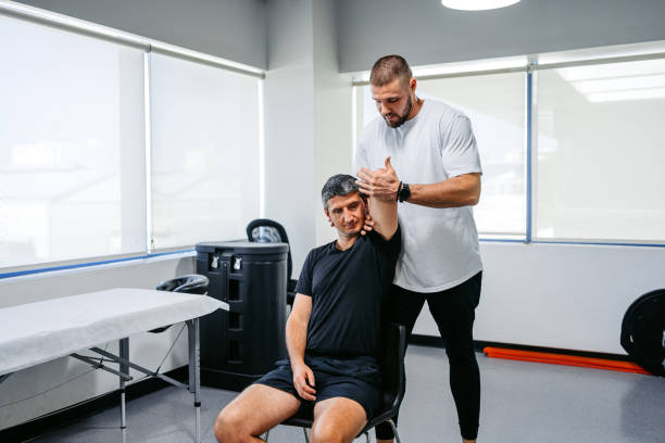 istock Physical Therapist Adjusting His Male Client's Arm In His Office 1962475289