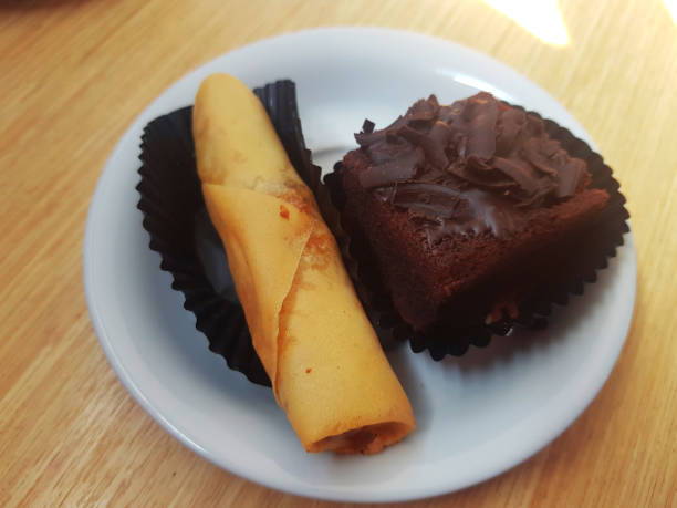 istock Fried snacks and a piece of chocolate cake on a small plate 1962477490