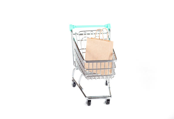Shopping Cart with Paper Bag on White Background: Conceptual Stock Photo