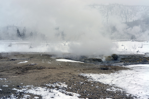 Geothermal pool in winter Yellowstone National Park steaming