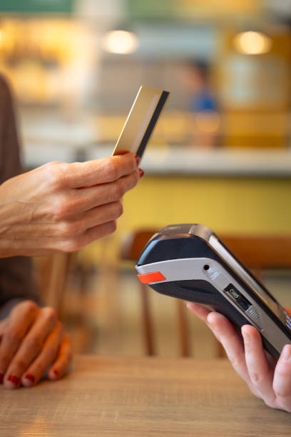 istock Vertical shot Customer paying with contactless credit card in a store. 1962519343
