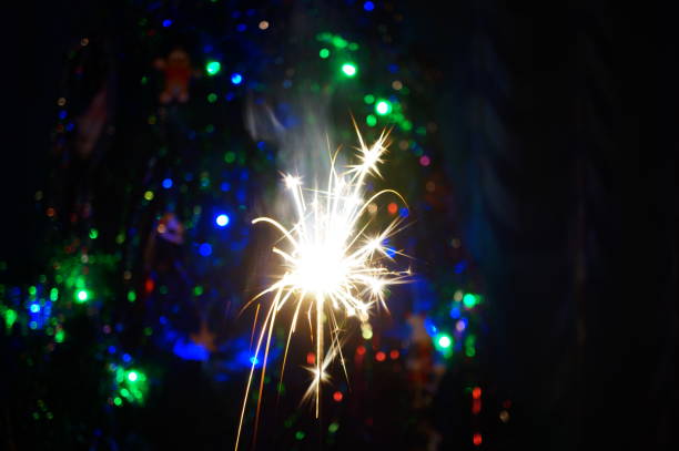 Sparkling sparklers at night. Bright Christmas background. A festive event.