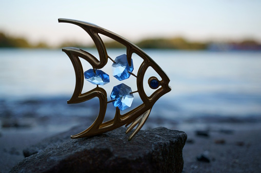 Decorative fish figurine decorated with blue glass.