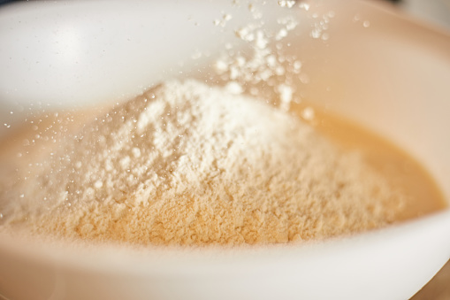 white flour splashing out of bowl