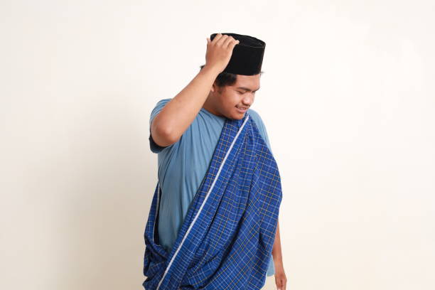 istock Asian muslim boy standing while showing confused gesture. Isolated on white 1962541573
