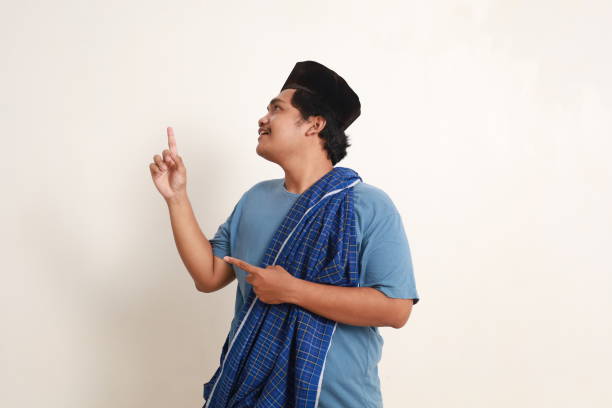 istock Asian muslim boy pointing above with happy face expression 1962546907