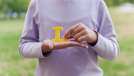 Child Holding Letter 