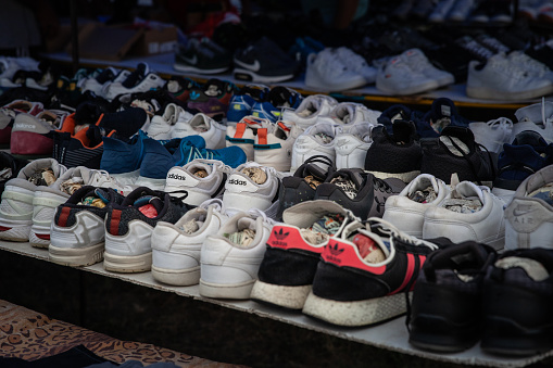 Mother's, father's and child's sneakers put one on another.