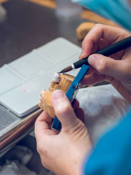 istock Crop female dental technician covering implants with ceramic 1962576249