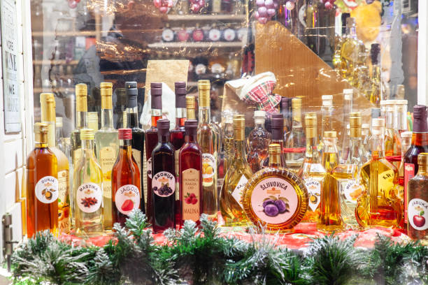 Various bottles of rakija, of different fruits sizes and flavours, on display in a market in Belgrade, Serbia Rakija is a traditional alcohol spirit of Balkans. Picture of various rakijas displayed In Belgrade, in a market, in Serbia. Rakia, rakija or Raki is the collective term for fruit brandy popular in the Balkans. serbian raki stock pictures, royalty-free photos & images