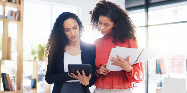 istock Teamwork, planning and strategy with women in office for discussion, commitment and collaboration. Tablet, notebook and conversation with employees talking for advice, development and meeting 1962581687