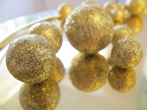 Abstract Background. Gold Colored And Silver Glittering Spheres. Usable for Topics Like Luxury, Wealth, Awards, Success.