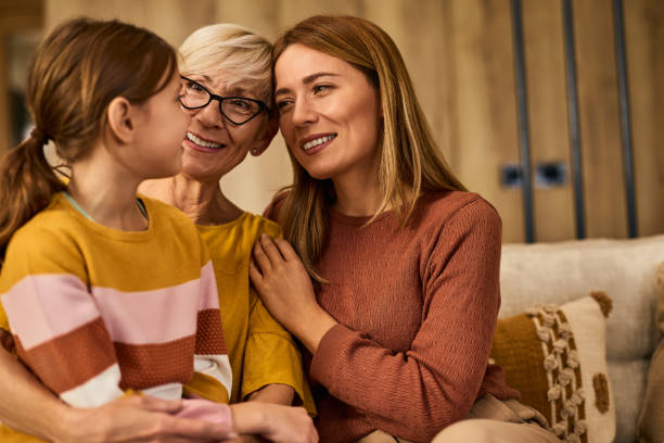 istock Three generations spending the day together, sitting on the couch, smiling. 1962590733