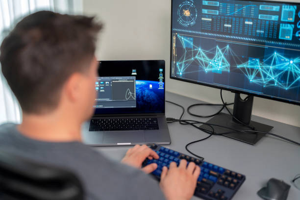 istock Unlock the world of digital guardianship featuring an engineer programmer working from the comfort of a home office. Dressed in casual attire, the developer is immersed in the intricate of coding, fortifying the security of an office network. 1962616448