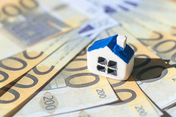 Miniature toy house placed on Euro bill banknotes. Concept for real estate costs, prices, buy or rent a house, hypothecary credit, interest.Selective focus,closeup.Blurred background and foreground. Miniature toy house placed on Euro bill banknotes. Concept for real estate costs, prices, buy or rent a house, hypothecary credit, interest.Selective focus,closeup.Blurred background and foreground. hypothecary stock pictures, royalty-free photos & images