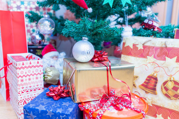 istock Decorated gift boxes under the Christmas tree.New Year gifts, different present boxes under Christmas tree in holiday eve, Christmastime celebration, home decorated indoors shot.Selective focus. 1962634841