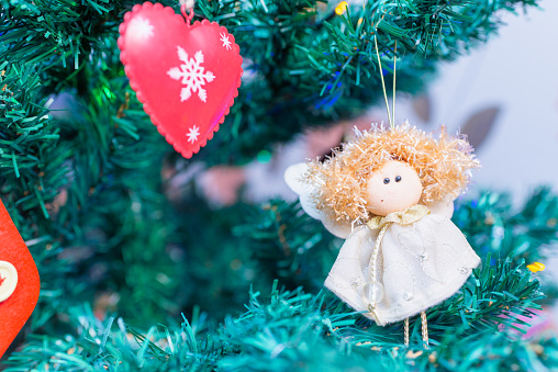 Straw angel on christmas tree with copy space