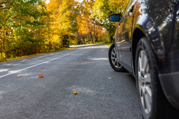 istock Car on asphalt road on autumn day at forest or park.Selective focus,copy space. 1962636969
