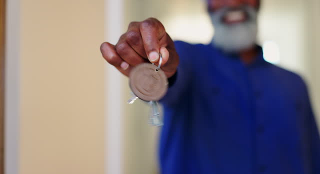 House keys, hands and closeup of senior man in new home with property, success or investment. Real estate, mortgage and zoom of elderly male real estate agent with dream, opportunity or property purchase offer