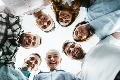 Low Angle View Of Smiling Faces Of Business Team In Office