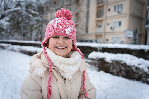 Portrait of an cute Caucasian girl, enjoying the snowy winter day