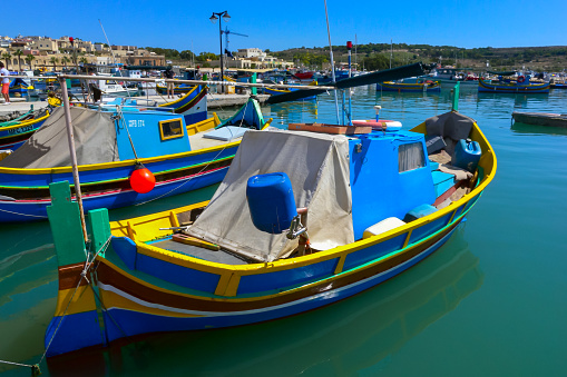 Marsaxlokk, Malta - September 14, 2012: Traditional eyed colorful boats Luzzu in the Harbor of Mediterranean fishing village Marsaxlokk, Malta