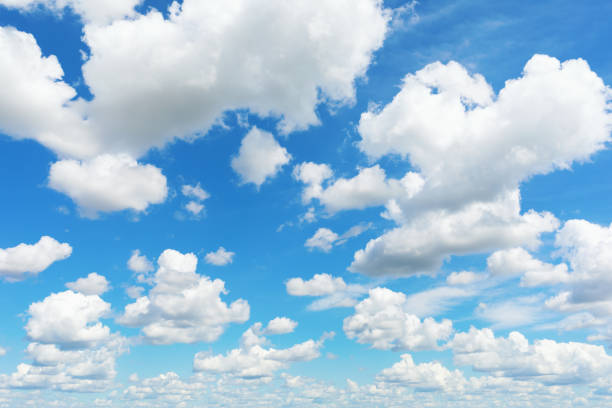 istock Snow-white clouds on a blue sky on a sunny summer day, template for designer 1962692204