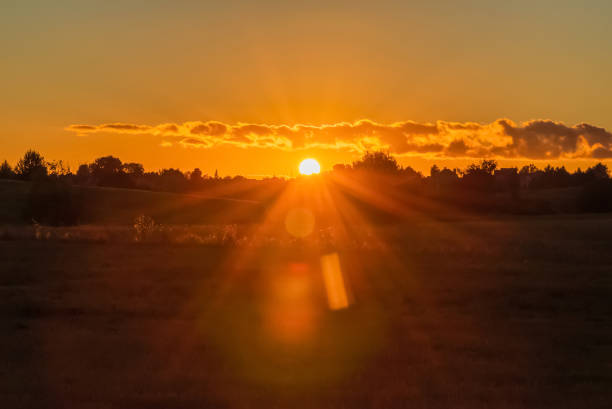 istock Beautiful Sunset,Sunrise Over Field Or Meadow. Bright Dramatic Sky Dark Ground. Countryside Landscape Under Scenic Colorful Orange Sky. 1962720719