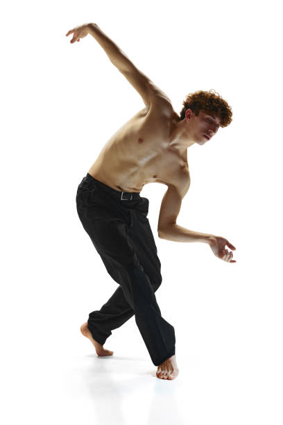 contemporary dance performances. male dancer in black pants, bending toward in dance pose against white studio background. - motion art naked studio shot imagens e fotografias de stock