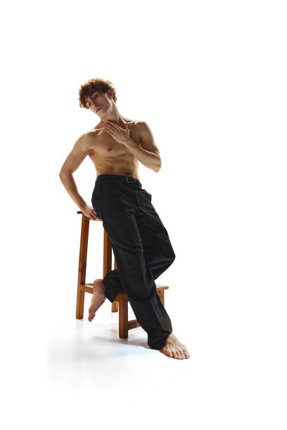 body size photo of attractive man with posing sitting on bar chair against white studio background. half-naked athletic male model. - motion art naked studio shot imagens e fotografias de stock